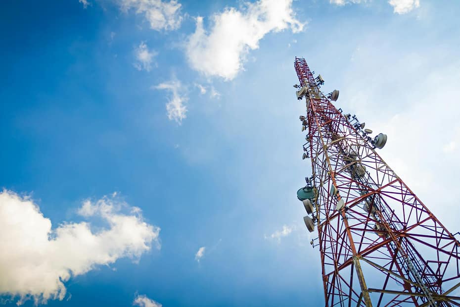 View of a tall telecom tower set against a clear blue sky in Depok, Indonesia.